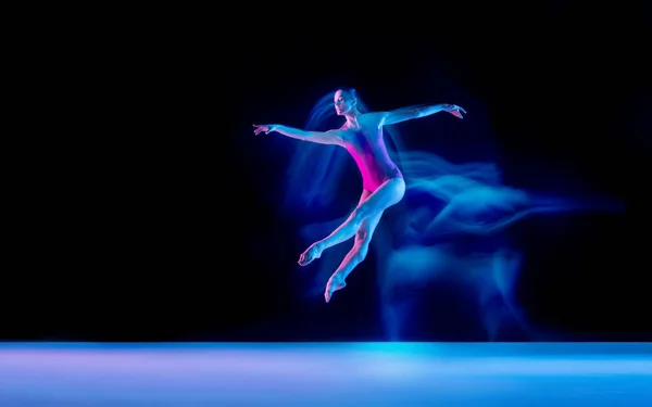 Jeune et gracieuse danseuse de ballet isolée sur fond de studio noir au néon lumière mixte — Photo
