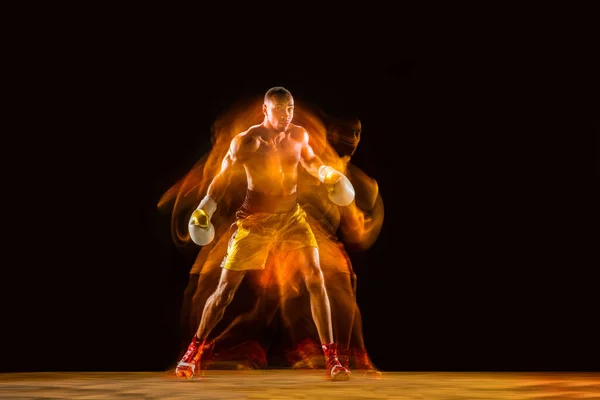 Entraînement de boxeur professionnel isolé sur fond de studio noir en lumière mixte — Photo