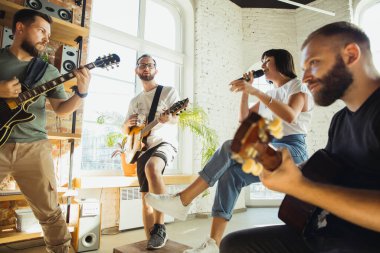 Müzik grubu enstrümanlarla sanat işyerinde bir araya geliyor.