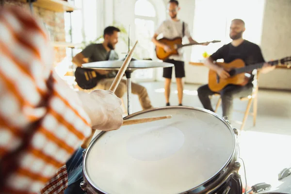 Musician band jamming together in art workplace with instruments