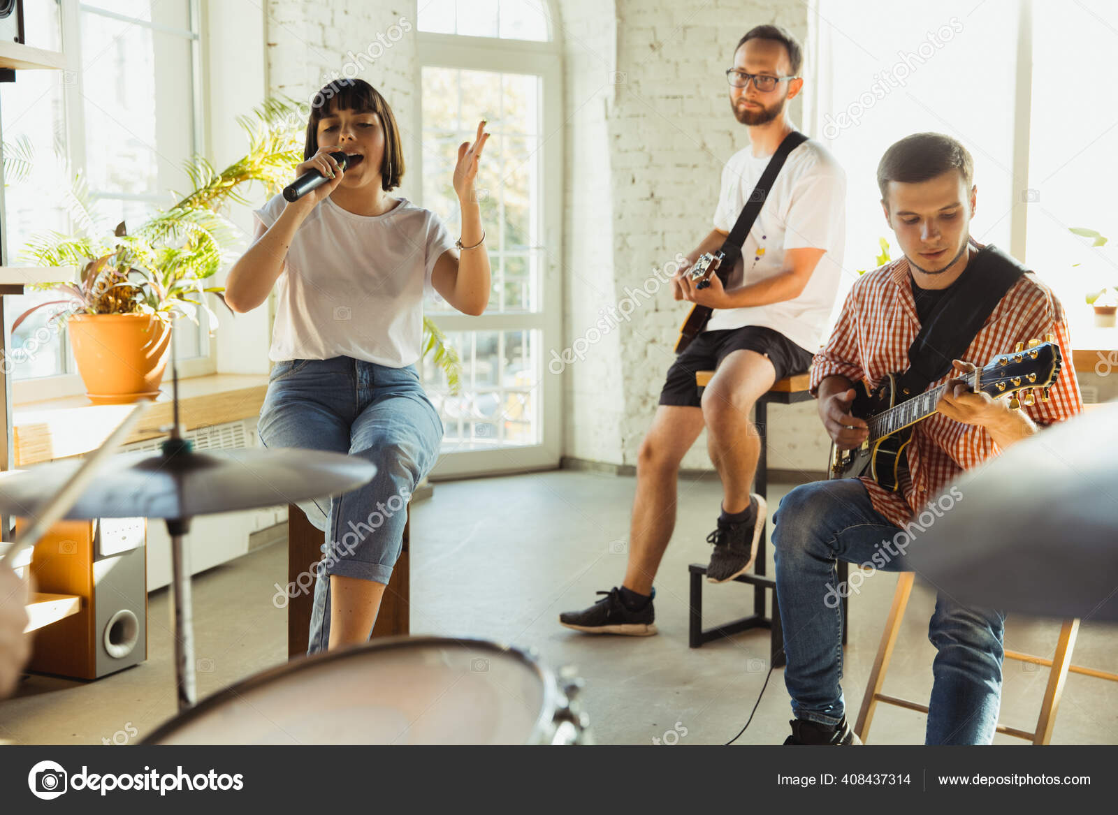 Musician band jamming together in art workplace with instruments Stock Photo by ©vova130555