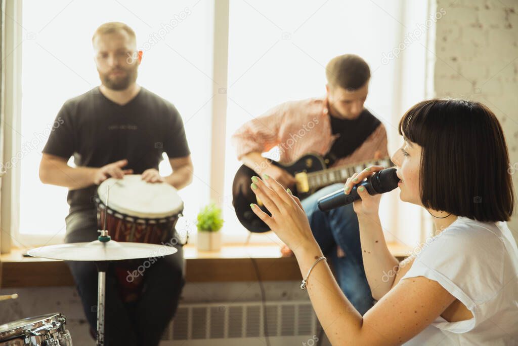 Musician band jamming together in art workplace with instruments