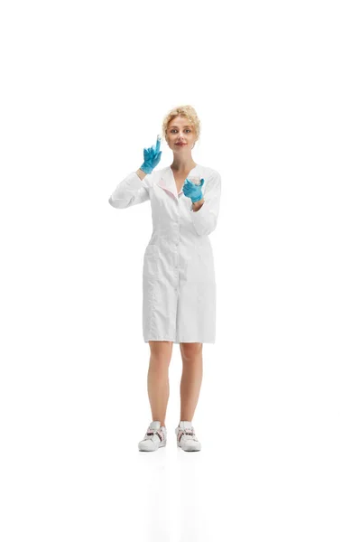 Portrait of female doctor, nurse or cosmetologist in white uniform and blue gloves over white background — Stock Photo, Image