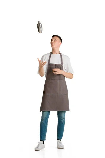 Isolated portrait of a young male caucasian barista or bartender in brown apron smiling — Stock Photo, Image