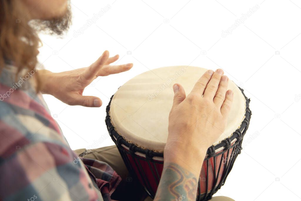 Man plays ethnic drum darbuka percussion, close up musician isolated on white studio background