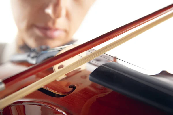 Close up woman playing violin isolated on white studio background — Stock Photo, Image