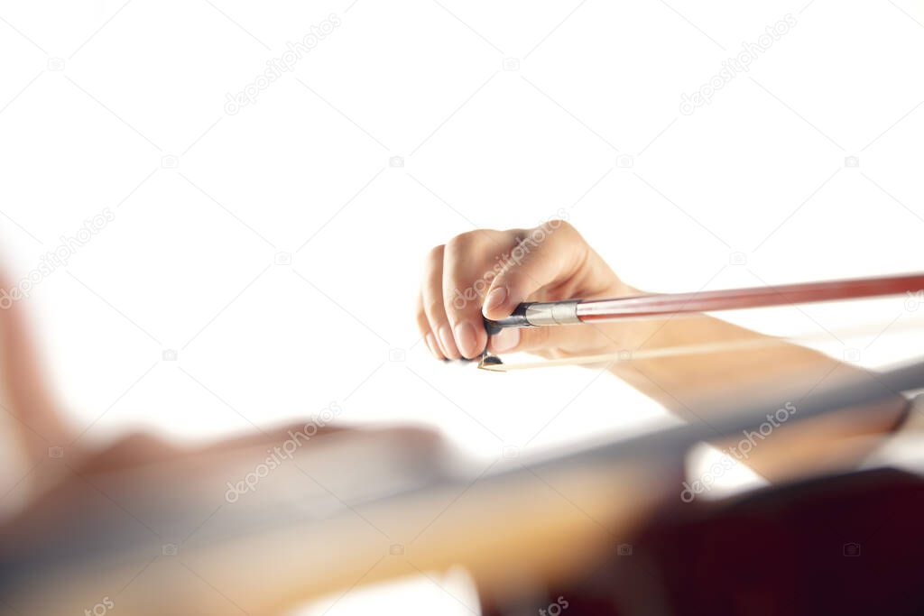 Close up woman playing violin isolated on white studio background