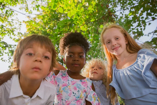 Interracial grupo de crianças, meninas e meninos brincando juntos no parque no dia de verão — Fotografia de Stock