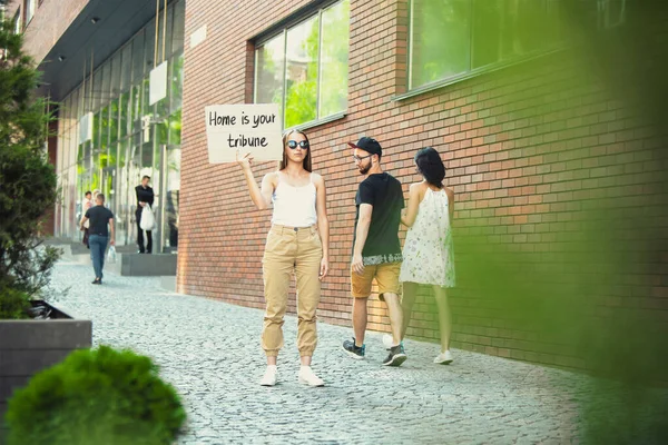 Dude with sign - woman stands protesting things that annoy him