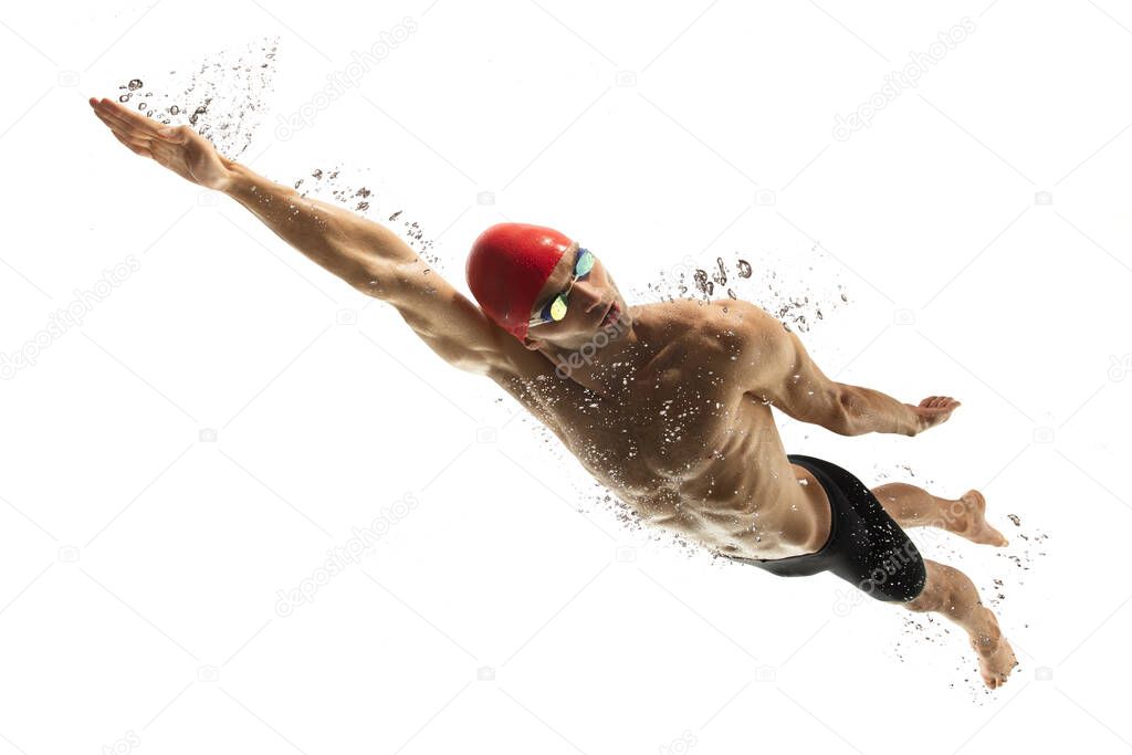 Caucasian professional sportsman, swimmer training isolated on white studio background