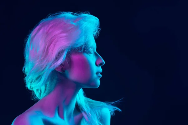 Portret van mooi albino meisje geïsoleerd op donkere studio achtergrond in neon licht — Stockfoto
