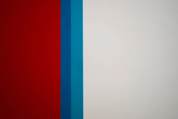 White, blue and red vertically divided colored paper background