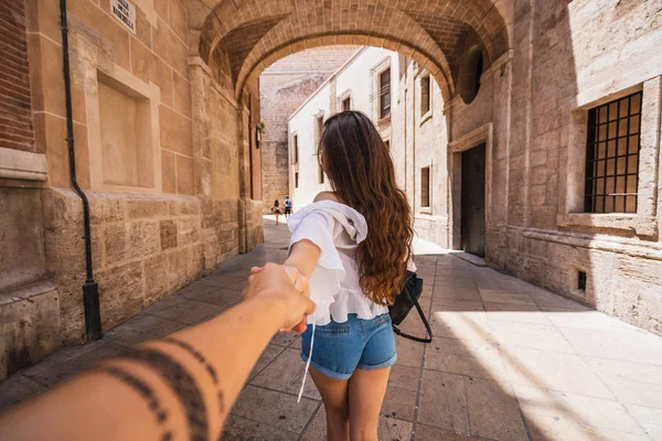 Back View Young Woman Leading Unrecognizable Person Hand While Walking — Stock Photo, Image