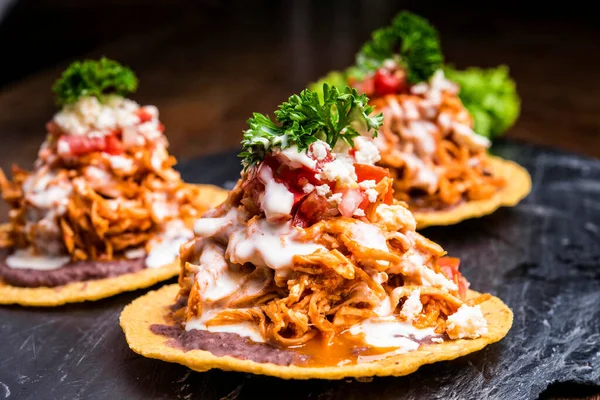 Hard shell Nachos with pulled pork and sauce