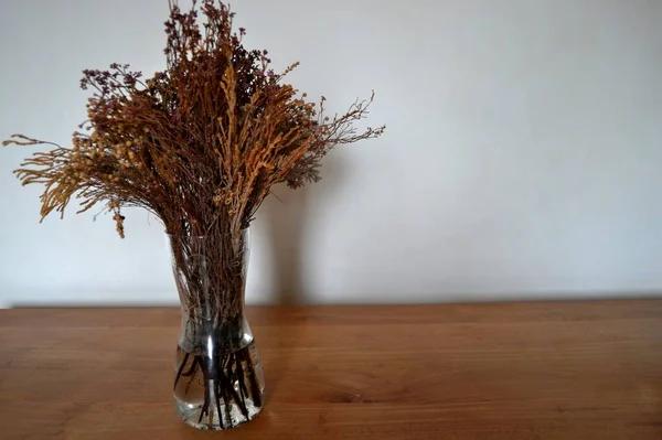 Dried flowers on wooden table
