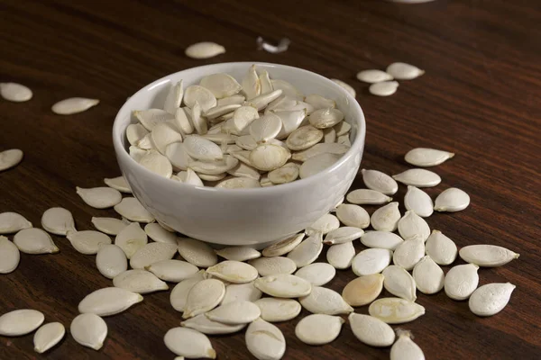 Vegan Food Raw Pumpkin Seeds Roasting White Dish Wooden Background — Stock Photo, Image