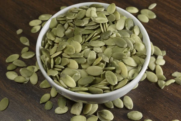 Vegan Food Raw Pumpkin Seeds Roasting White Dish Wooden Background — Stock Photo, Image