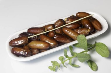 Hurmalar, plastik kutuya doldurulmuş, satılmaya hazır, beyaz arka plan. İş konsepti. Yakın plan..