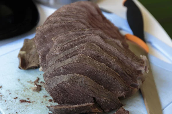 Sliced boiled beef on a cutting board. Selective focus. Closeup.