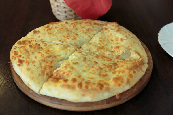 Fresh cheese pizza in a plate on the table, Italian traditional appetizer, high angle view.