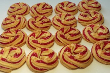 Beyaz arka planda çilek reçelli kurabiyeler..