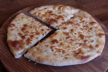 Tahta tabakta taze peynirli pizza, İtalyan ve Kafkasyalı geleneksel aperatif, yemeye hazır..