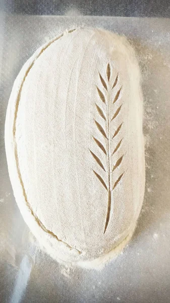Bread dough prepared for baking. Grinding and herringbone decoration