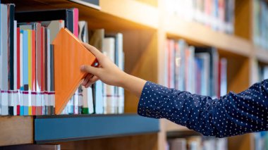 Erkek seçimi ve halk kütüphanesinde turuncu kitap toplama sağ. Seçilen ders kitabı çekerek. Eğitim Araştırma ve kendini Üniversitesi yaşam kavramları öğrenme