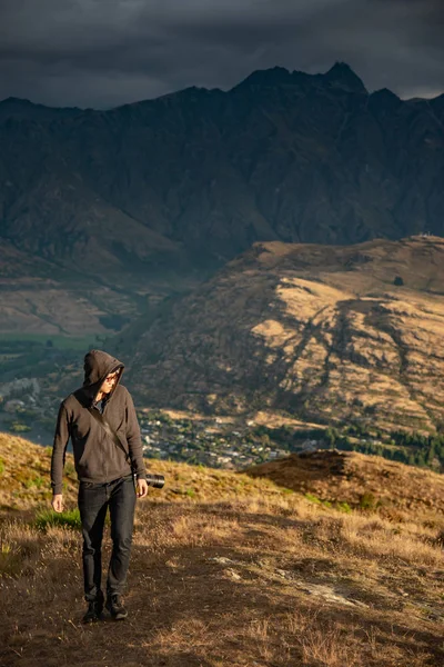 Tânăr Fotograf Sex Masculin Plimbă Dealul Queenstown Peisaj Montan Fundal — Fotografie, imagine de stoc