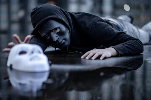 Mystery Hoodie Man Broken Black Mask Lying Rain Trying Grab — Stock Photo, Image