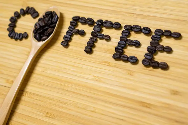 Coffee Word Made Coffee Beans Spoon Wooden Background Top View — Stock Photo, Image