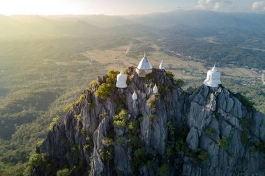 Spectacular aerial view of floating pagodas on the mountain cliff at Wat Chaloem Phra Kiat in Chae Hom District, Lampang province, Thailand.