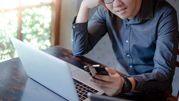 Young Asian Happy Businessman Male Entrepreneur Using Smartphone Laptop Computer — Stock Fotó