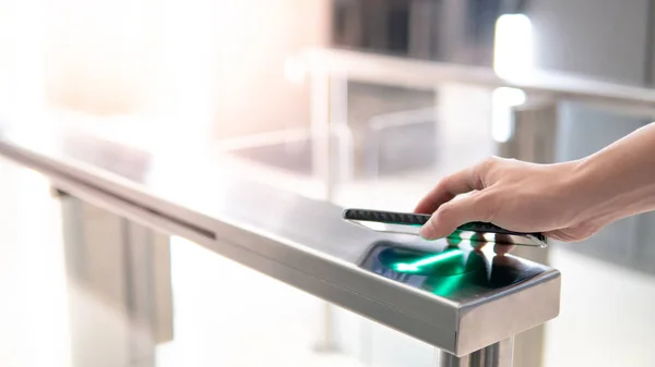 Using smartphone to open automatic gate machine — Stock Photo, Image