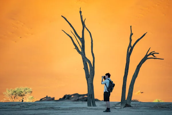 Азіатський фотограф стоїть в deadvlei, Намібія — стокове фото