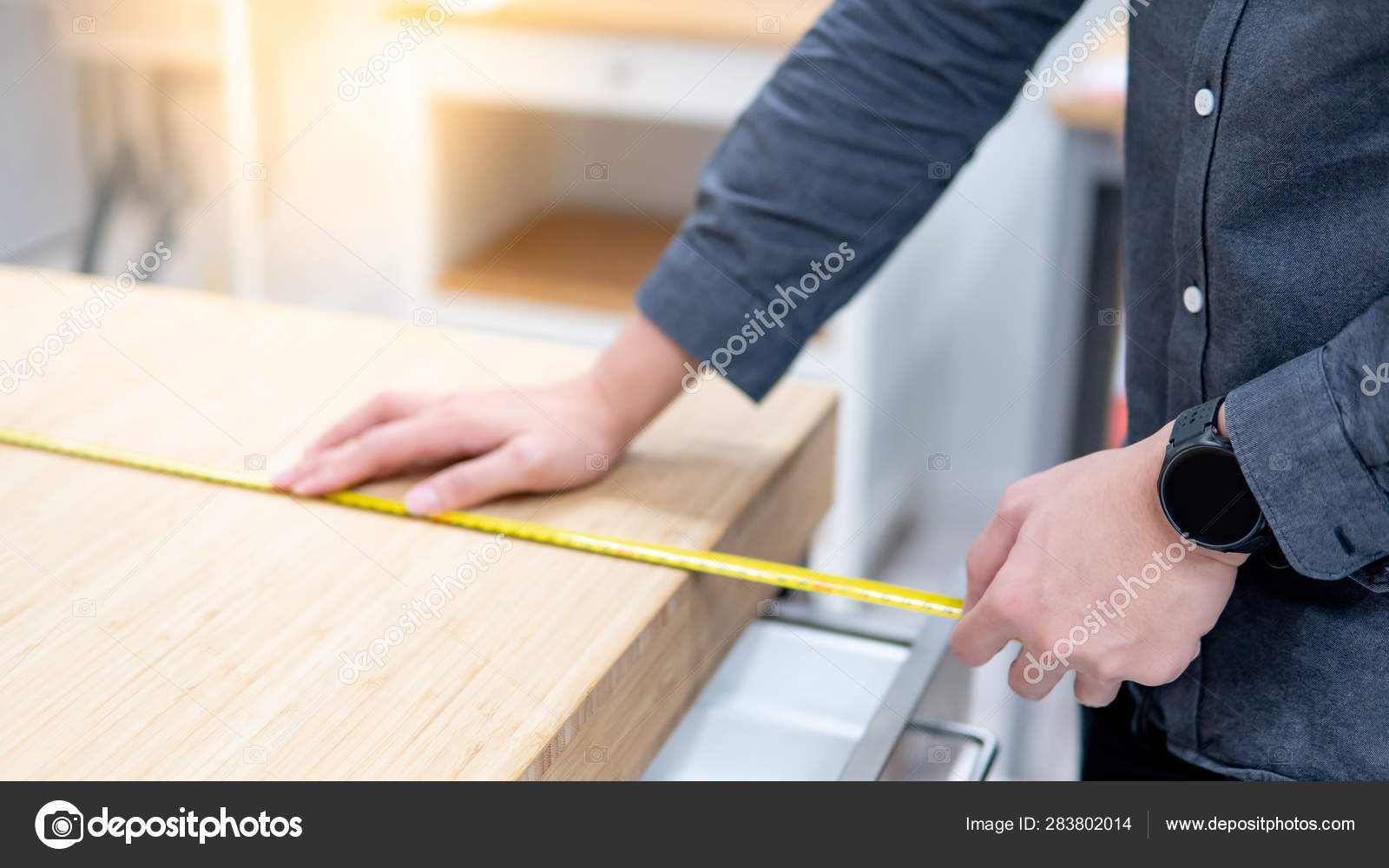Male Hand Using Tape Measure On Countertop Stock Photo