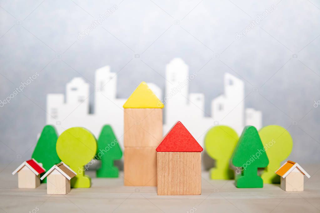 Wooden house and tree toy models on the table