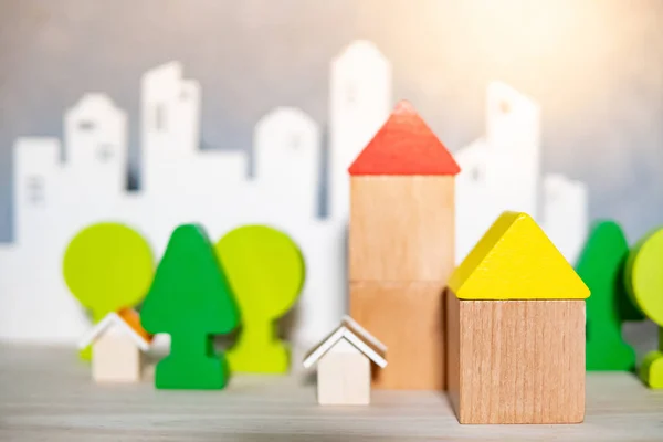 Wooden house and tree toy models on the table