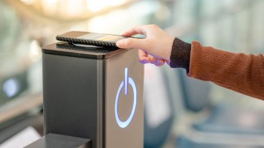 Erkek, akıllı telefonu kablosuz şarj cihazına ya da şarj aletine bağlıyor. Kamu alanındaki cep telefonu elektrik yükleme istasyonu.