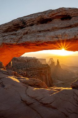 Güneş doğarken Mesa Kemeri, Amerika Birleşik Devletleri 'nin Utah eyaletinin kuzeyinde, San Juan İlçesi' nde, Canyonlands Ulusal Parkı 'ndaki bir uçurumun kenarına tünemiş muhteşem bir doğal taş kemer..