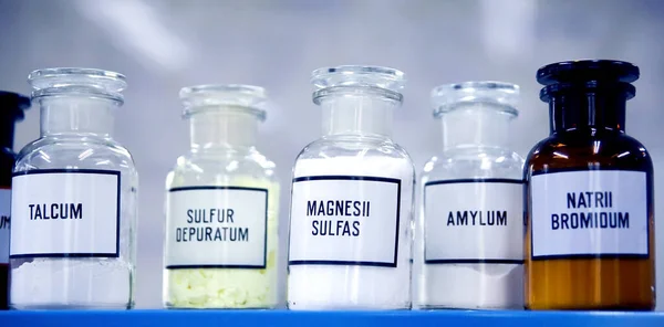 Composition of a bottle with medicines and chemicals stands on the shelf