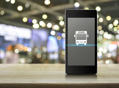 Otobüs düz ahşap masa üzerinde modern akıllı cep telefonu ekran simgesine bulanıklık ışık ve gölge, Alışveriş Merkezi, iş ulaşım hizmeti çevrimiçi kavramı