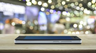 Bulanıklık ışık ve alışveriş merkezinin gölge üzerinde ahşap masa üzerinde modern akıllı cep telefonu ekranında Harita pin konum düğmesi, Harita işaretçisi navigasyon online kavram