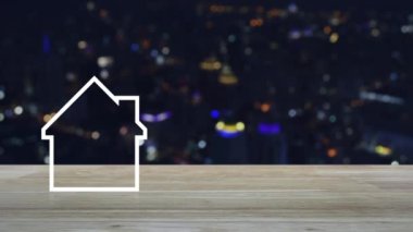 Ev ahşap masa üzerinde kopya alanı düz simgesiyle bulanıklık renkli gece ışık şehir kule ve gökdelen, iş gayrimenkul kavramı
