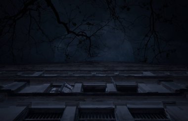 Ancient architecture building over dead tree, full moon and cloudy spooky sky, Halloween mystery background