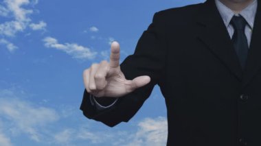 İş adamı, beyaz bulutlu mavi gökyüzü üzerinde e-posta simgesine basıyor. İş dünyası bizimle çevrimiçi bağlantı kuruyor.