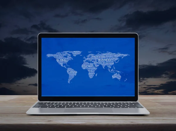 Global business words world map with modern laptop computer on wooden table over sunset sky, Global business online concept, Elements of this image furnished by NASA