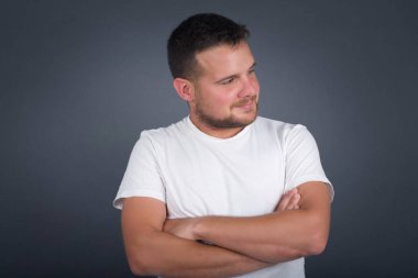 Closeup portrait displeased pissed off angry grumpy pessimistic man with bad attitude, arms crossed looking sideways. Negative human emotion facial expression feelings