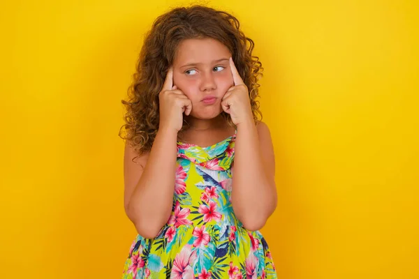 Little Girl Wearing Summer Dress Yellow Background Thoughtful Expression Looks Stock Image