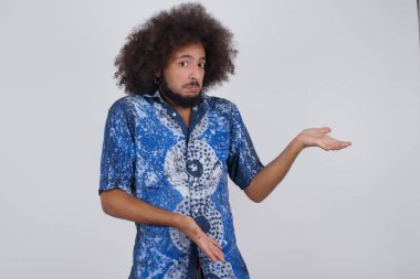 Yakışıklı, beyaz bir genç iki eliyle tuhaf bir şey gösterip 